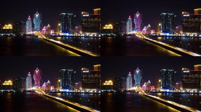 4k时间流逝: 澳门夜间，桥上的交通车灯光步道的鸟瞰图朝着照明的酒店建筑物行驶。
