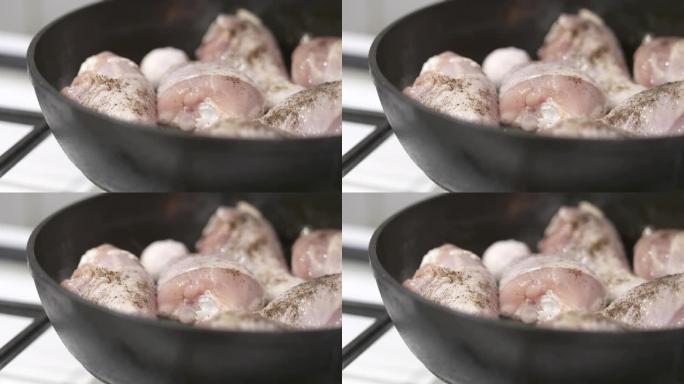 在铸铁煎锅中制作平底锅炸鸡腿。