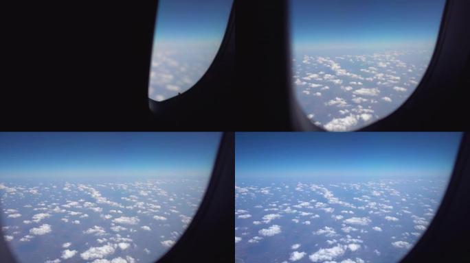 透过飞机的窗户可以看到天空和云。