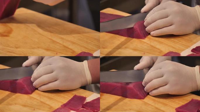 A厨师slicing tuna fillet