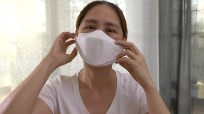 一名亚洲华人女性意识到2019年新型冠状病毒感染的疫情时戴上口罩，慢镜头拍摄