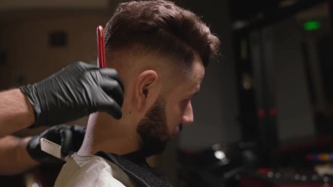 自信的理发师用剃刀刮客户的脖子