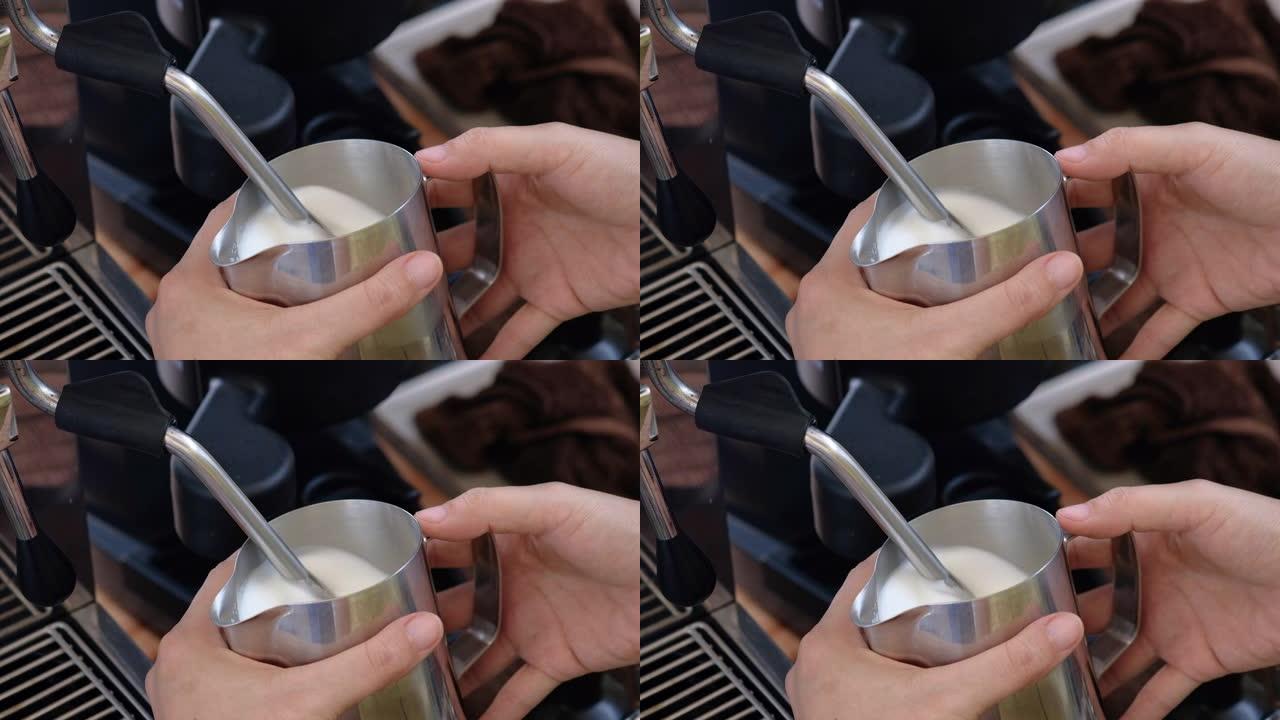 咖啡师在喝拿铁艺术之前先在水罐中蒸牛奶。