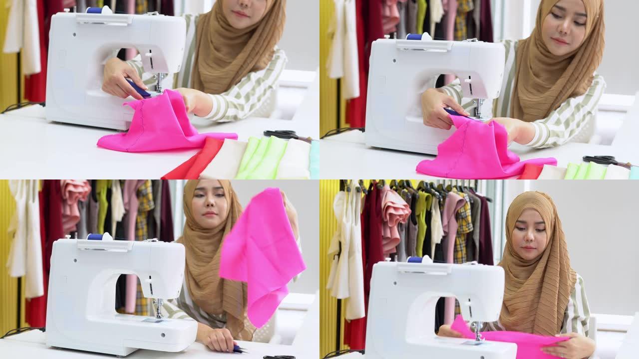 穆斯林女性时装设计师在家庭工作室的电动缝纫机上纺织，倾斜镜头