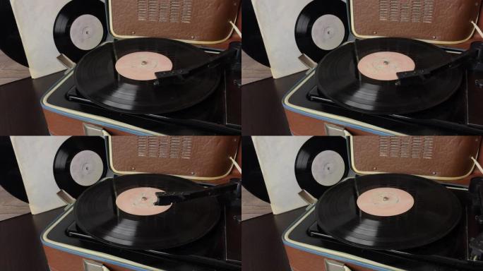 黑胶唱片在唱机的光盘上旋转。播放结束时拾音器头上升。一个人把皮卡放在架子上。