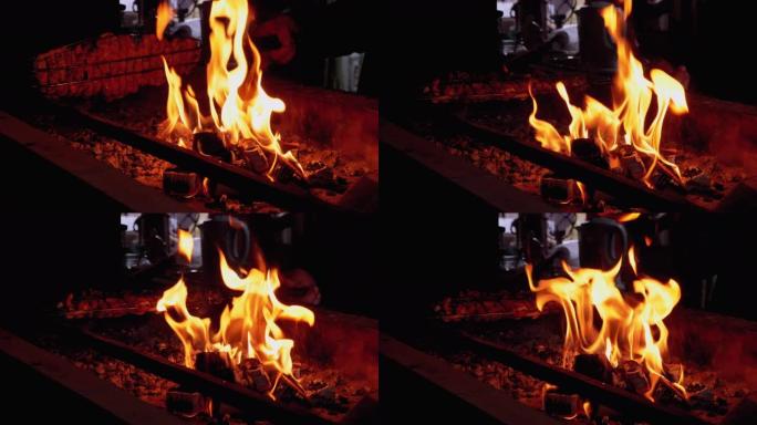烧烤是由餐厅的烤架上的火煮熟的。煤中的红色火焰
