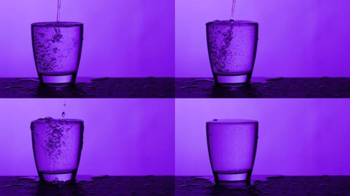 水倒入玻璃并溢出-紫色背景，慢动作