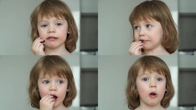 高加索有趣女孩的肖像3岁女孩吃巧克力胃口大。孩子被巧克力弄脏了。