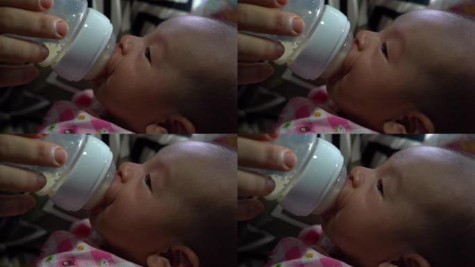 婴儿正在喝奶瓶中的牛奶