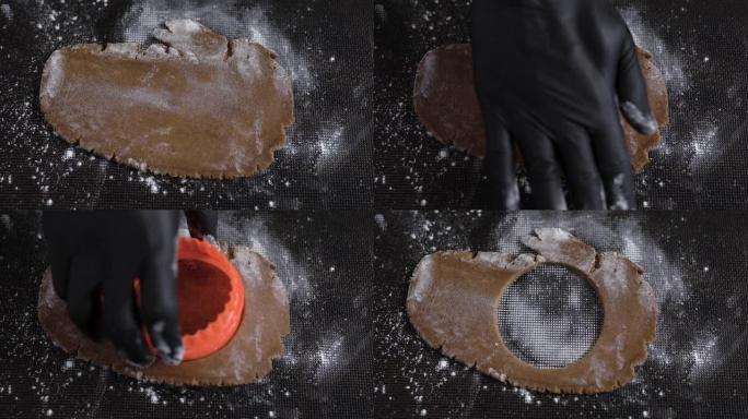 用rolling面杖将饼干面团滚动。厨师用表格做饼干。一切都在特殊的硅胶垫上完成