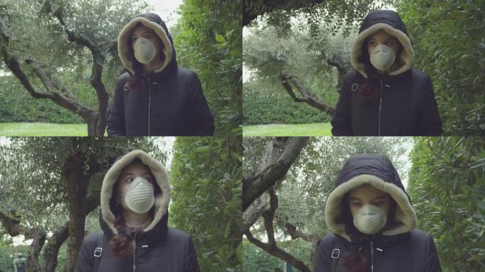 年轻女子戴着面具，保护自己在大自然中行走时免受新型冠状病毒肺炎。慢动作拍摄