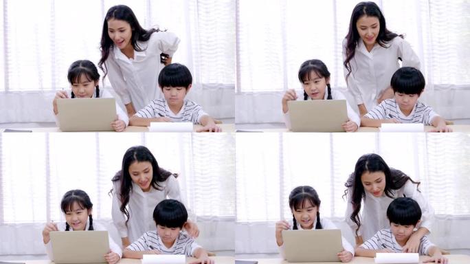 家庭教育技术，亚洲年轻的母亲正在客厅里教家庭作业，小女孩坐在平板电脑上寻找学习信息。