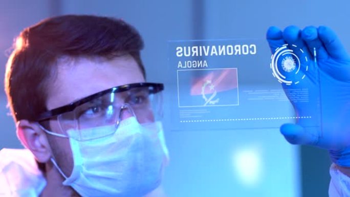 研究人员在观察安哥拉的冠状病毒结果。实验室数字屏幕上的安哥拉国旗