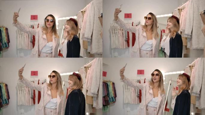 魅力女人在时尚精品店用智能手机录制视频