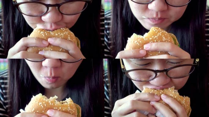 吃汉堡的亚洲女人。