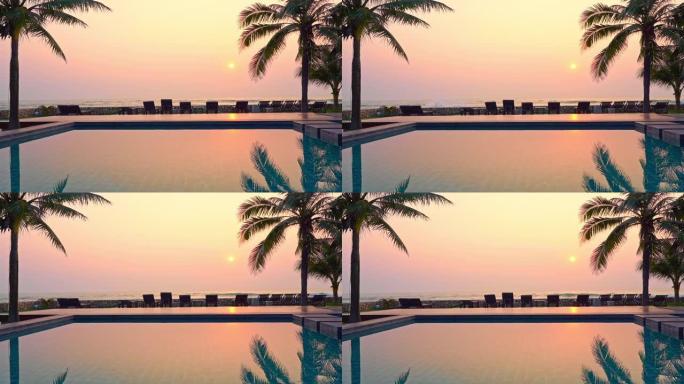 室外游泳池近海洋海滩，日落时间有棕榈树
