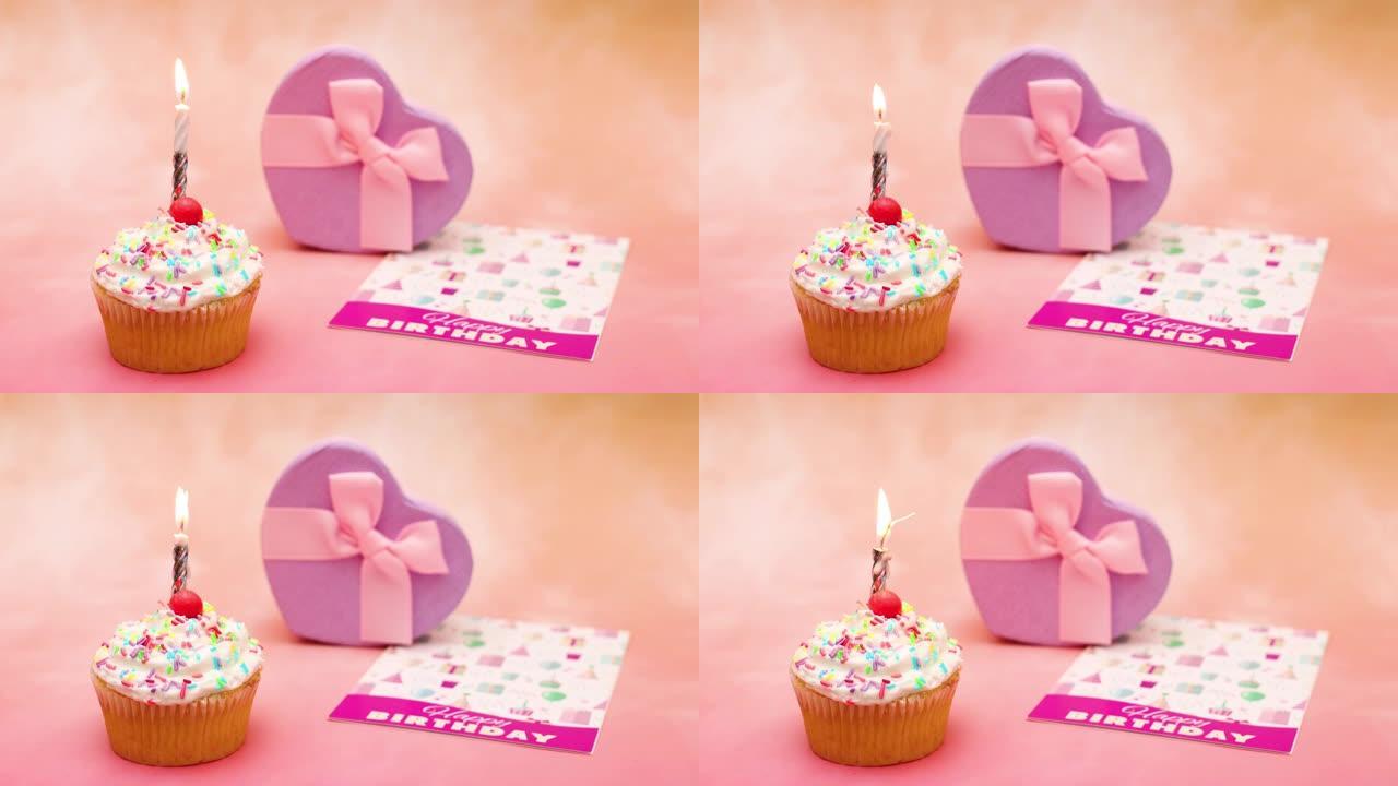 生日蜡烛的时间流逝在桌上美味的杯子蛋糕上燃烧，带有礼物和贺卡-停止动作