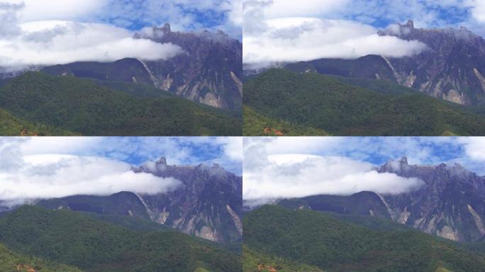 马来西亚沙巴州昆达桑山基纳巴卢山上快速移动的雾和云的4k镜头