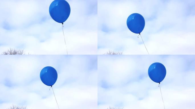 一个蓝色的气球在一根绳子上，在风中飞行的蓝天上，有云彩，4k视频