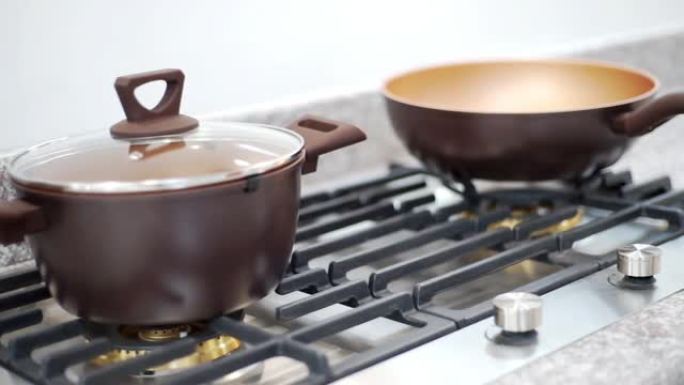 在室内现代厨房的煤气炉上烹饪的新用具。