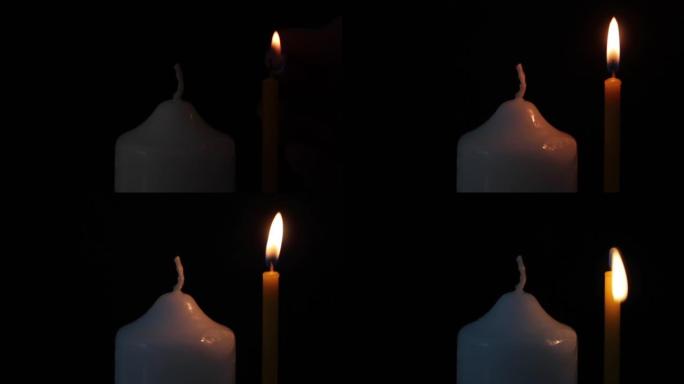 黑色背景上有火柴的男性手点燃蜡烛。特写