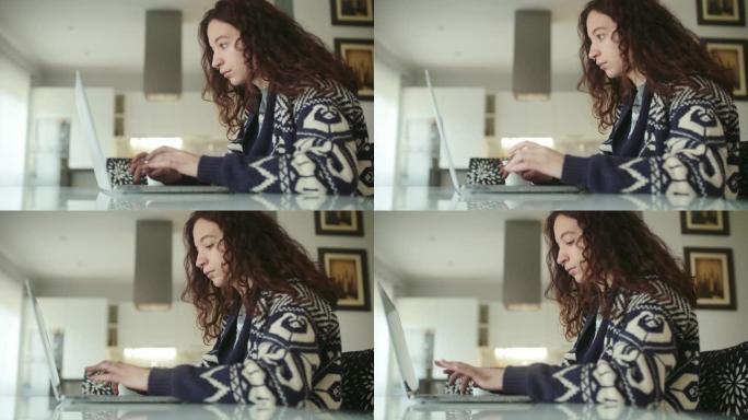 年轻女子早上开始用笔记本电脑工作。多莉开枪