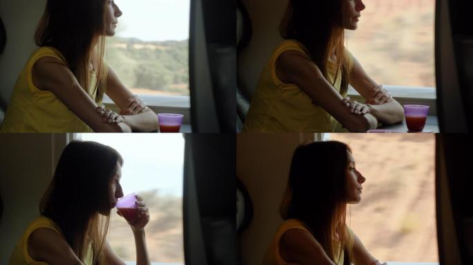迷人的白人女孩在高速列车4k窗口旁边喝一杯饮料
