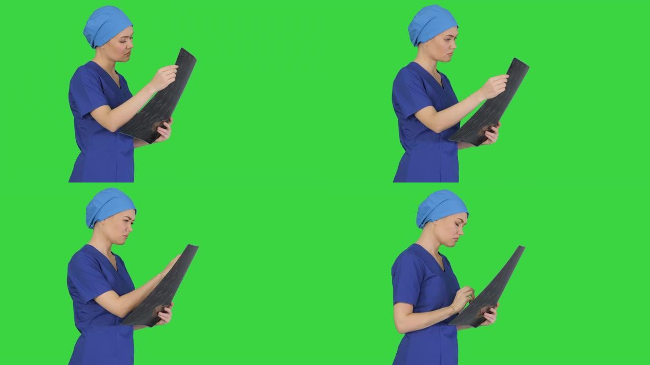 严肃的女医生在绿色屏幕上看脑部MRI扫描，色度键