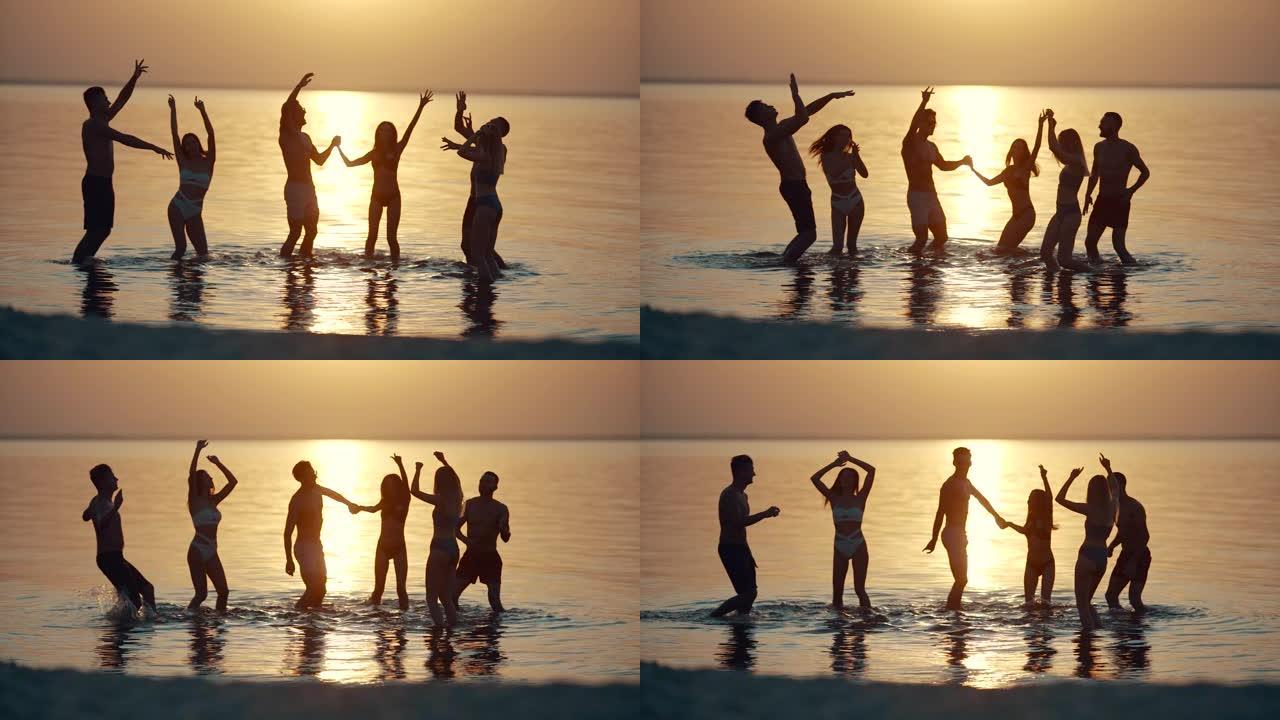 六个朋友在美丽的日落下在水中闲逛。慢动作