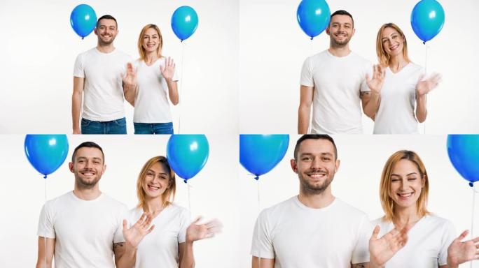 微笑的男人和女人举起双手问候并拿着气球