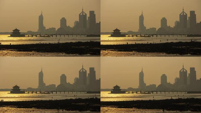 日落时间青岛城市景观著名海滩地段潮汐码头延时全景4k中国