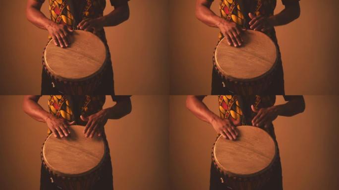 非裔美国人音乐家在棕色背景下演奏传统鼓的细节。