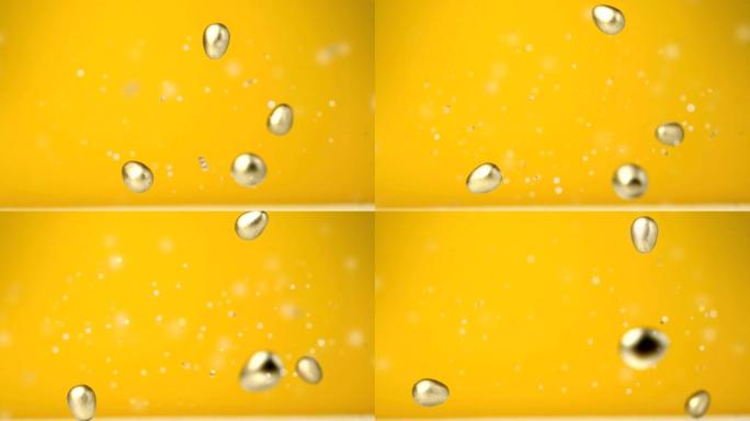 黄色背景上四个巧克力金色复活节彩蛋掉落和五彩纸屑飞舞的动画