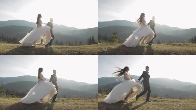 新婚夫妇。白人新郎和新娘在山坡上奔跑。婚礼夫妇