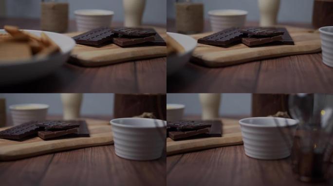 巧克力蛋糕原料: 麦芽牛奶饼干，一碗可可，一杯酪乳，一块黄油，一串牛奶和黑巧克力。