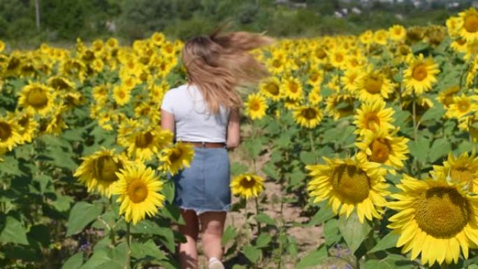 女孩在田野里奔跑，向日葵的头发在风中飘扬。慢动作的人。