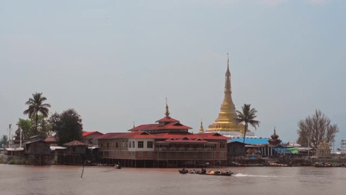 缅甸因勒湖海岸线附近的传统建筑，独木舟经过