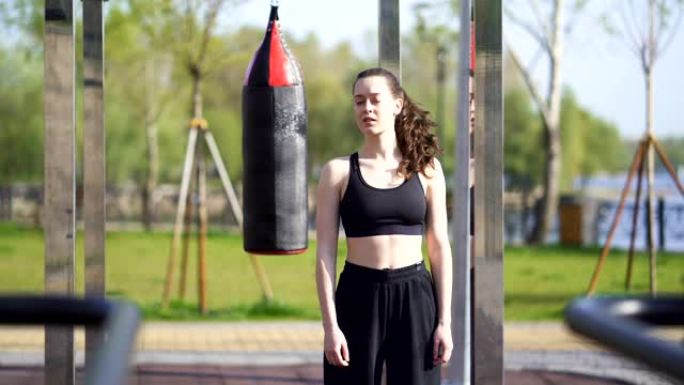 年轻女子拳击手，跆拳道运动员准备在街头训练场训练。