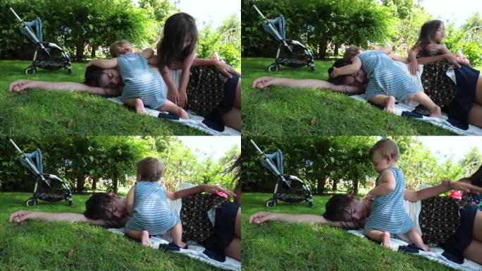 妈妈想睡在外面的草地上。妈妈从婴儿那里休息一下，婴儿想要注意