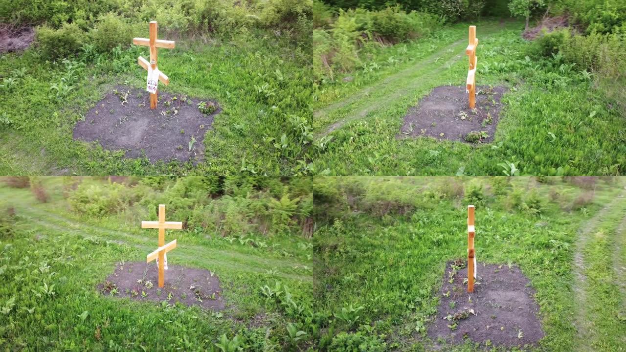一个埋在地下的基督教木制十字架，一个做礼拜的纪念碑，一个悬挂在十字架上的乌克兰刺绣毛巾。