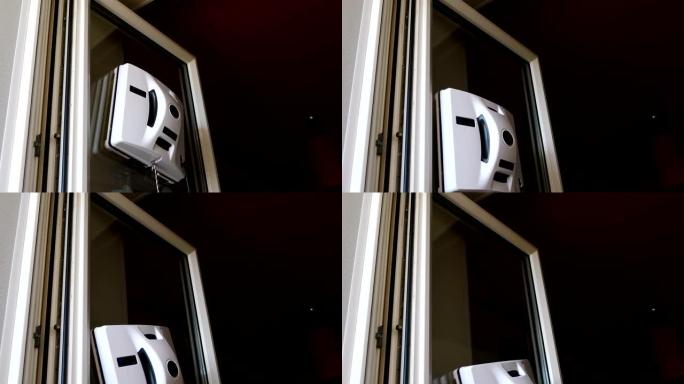 家政助手。机器人玻璃洗衣机方形在窗户上移动。公寓中的小型机器人玻璃洗衣机清洁窗户。非接触式玻璃清洗机