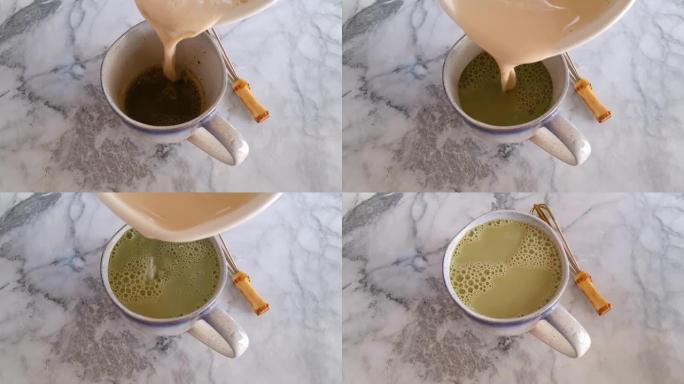 Pouring milk in matcha tea making拿铁