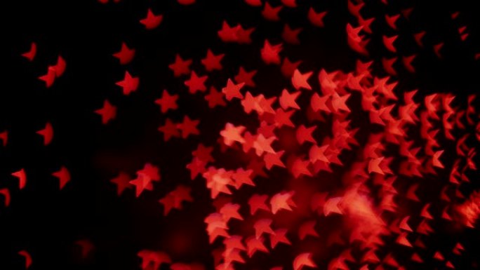夜空背景下的真实烟花中的红星形Bokeh。