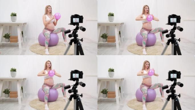 一位运动的孕妇年轻博客作者谈论球操。