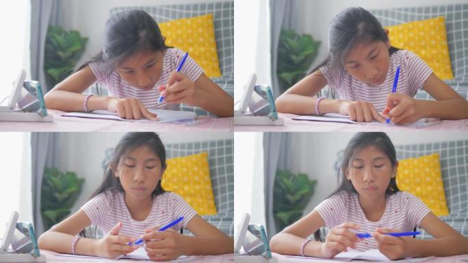 亚洲女孩在家在线学习家庭教育，她的狗睡在地板上，检疫生活方式的概念