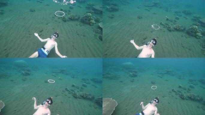 一个学习如何在水下制作泡泡环的人。