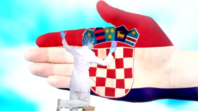 戴着医用口罩和手套的护士洗大手，涂上克罗地亚国旗的颜色。国家保健。洗手概念。病毒保护。疾病预防