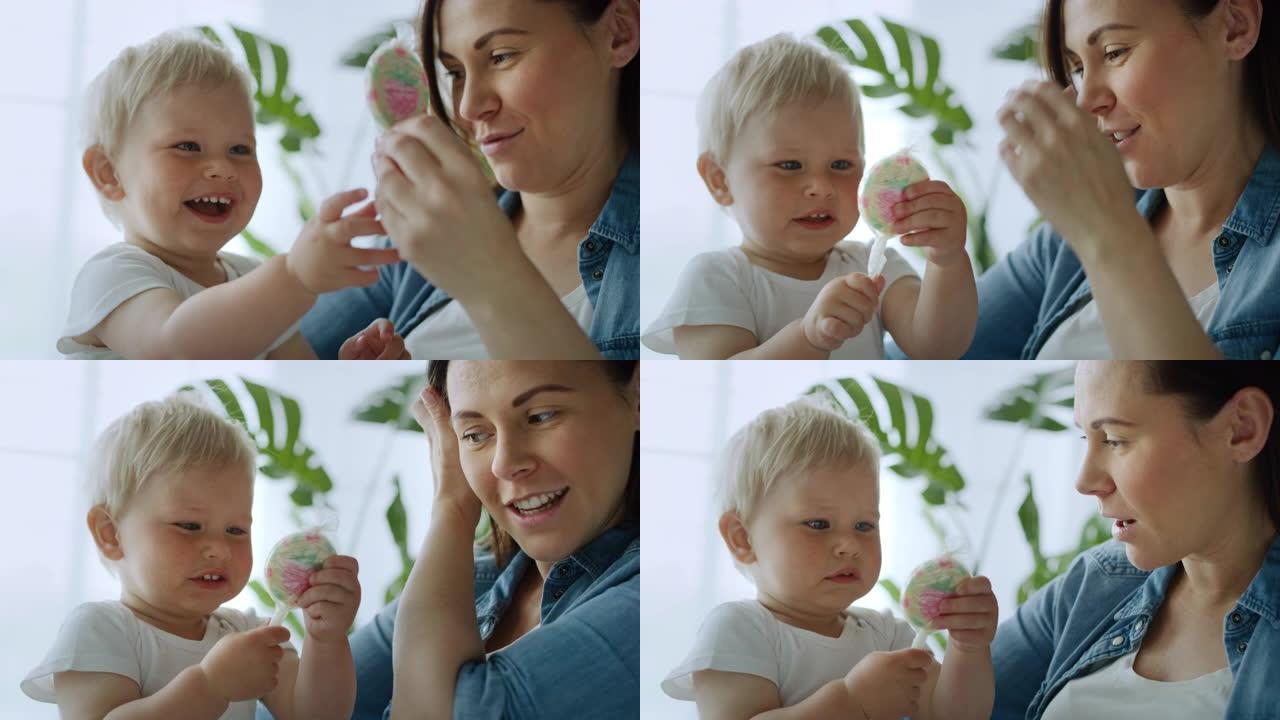孕妇和她可爱的小孩棒棒糖的视频。用8k的红氦相机拍摄