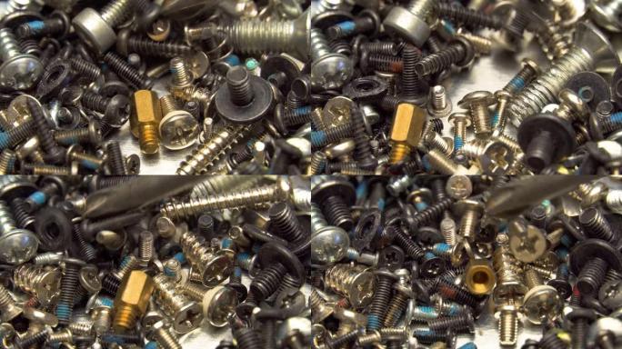 盒子里有很多螺丝，主人正在用螺丝刀寻找合适的螺丝。