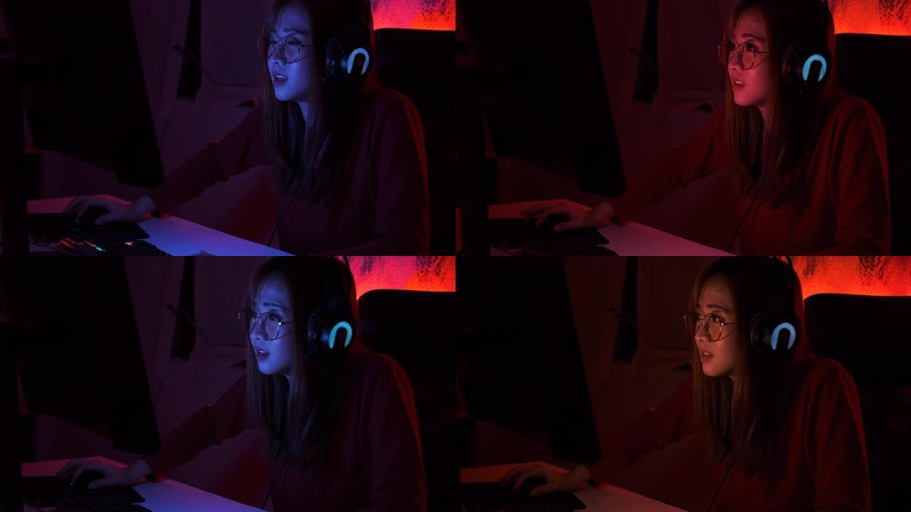 职业玩家玩家年轻的亚洲女性玩在线视频游戏射击fps锦标赛排名网络互联网在夜间红色霓虹灯室与游戏锦标赛